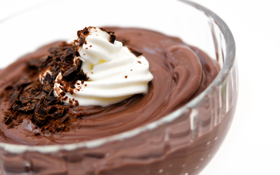 Dark chocolate pudding with whipped cream and chocolate shavings