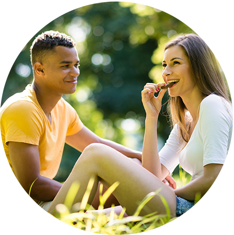 Couple sitting in field enjoying their homemade chocolate